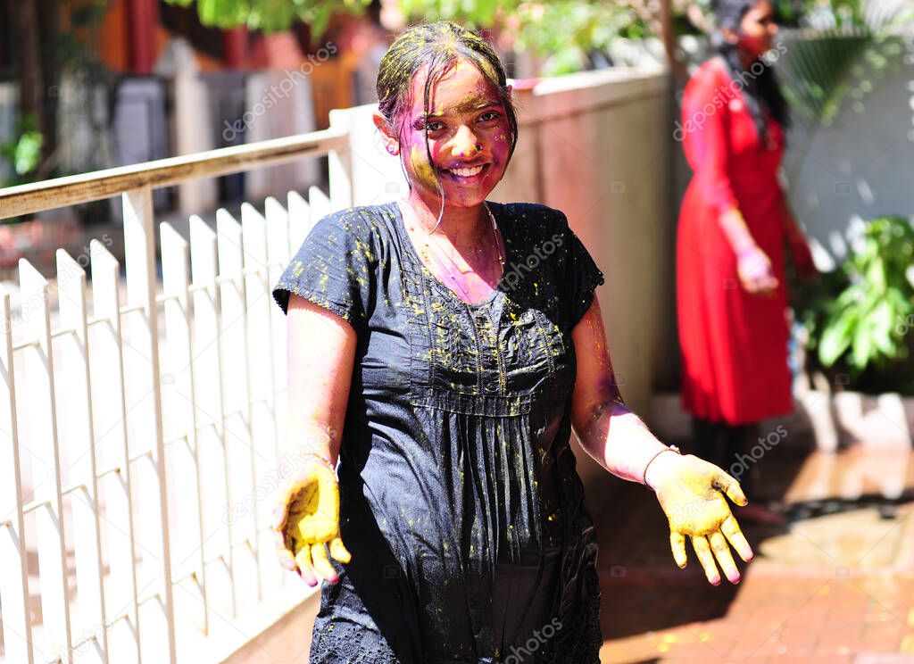 Girl splashed with colours on the festival of Holi