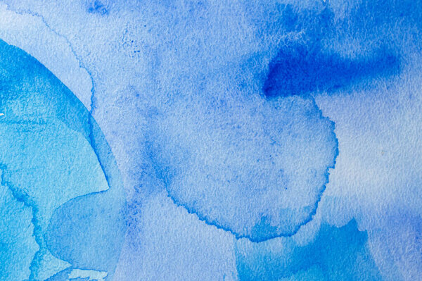 Abstract blue watercolor background with different layers on paper texture