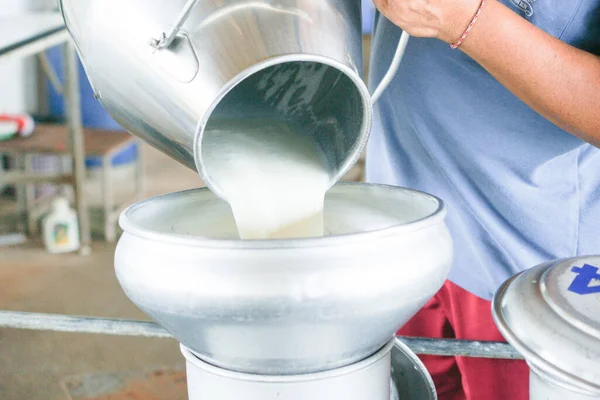 牛乳タンクに新鮮な牛乳を注ぐ労働者を変換します — ストック写真