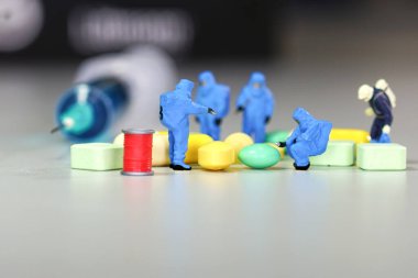 Tıp haplarıyla uğraşan minyatür bilim adamı                                