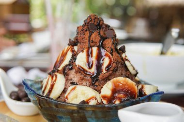 Çikolatalı bingsu mu yoksa üstünde muz olan buz tanesi mi? Tatlı.