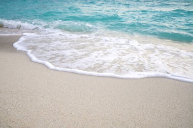 Kumsal ve su dalgalı kum. Deniz köpüğü. Deniz dalgası. Doğa arkaplanı.