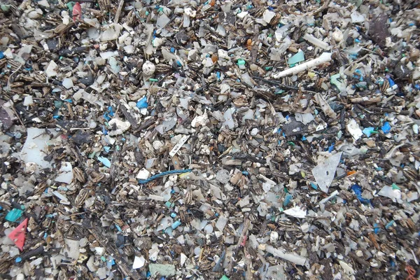 Micro plastics marine debris on the sand beach.