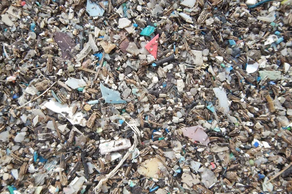 Micro plastics marine debris on the sand beach.