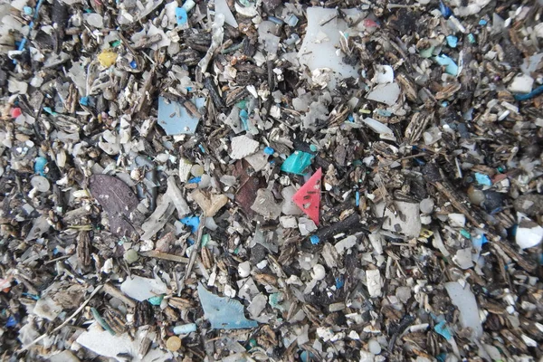 Micro plastics marine debris on the sand beach.