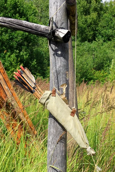 Bow arrows quiver hanging on the wood log