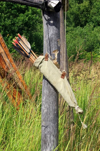 Bow arrows quiver hanging on the wood log