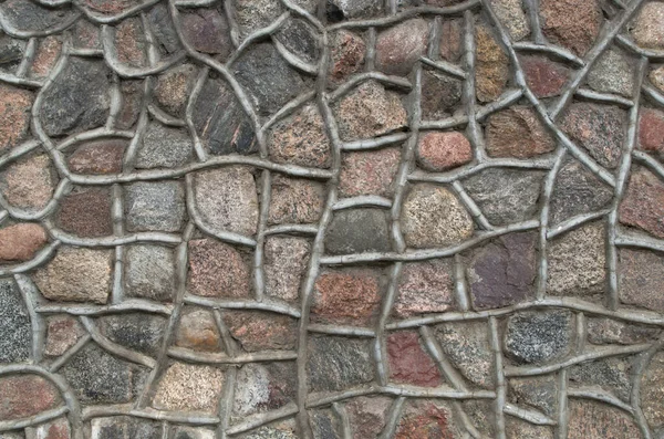 用褐色 米黄色和粉色调的花岗岩石材制成的结构碎片 在坚固坚固的栅栏外墙石材周围有厚厚的水泥华丽的轮廓 — 图库照片