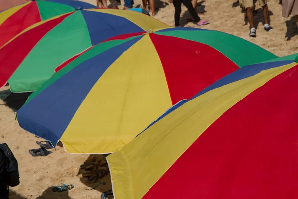 line up of colorful big umbrella at the baech