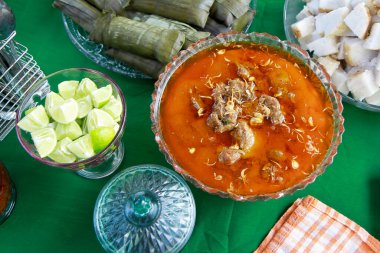 traditonal indonesian food coto makassar with lime slices clipart