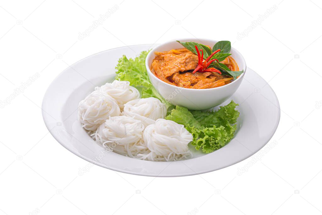 Front view of rice noodles in chicken red curry preserved bamboo shoot with vegetables in plate isolated on white background. Kanom Jeen of Asian meal traditional style. Popular Thai food.