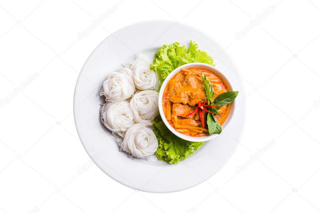 Above view of rice noodles in chicken red curry preserved bamboo shoot with vegetables in white plate isolated on white background. Kanom Jeen of Asian meal traditional style. Popular Thai food. Top view
