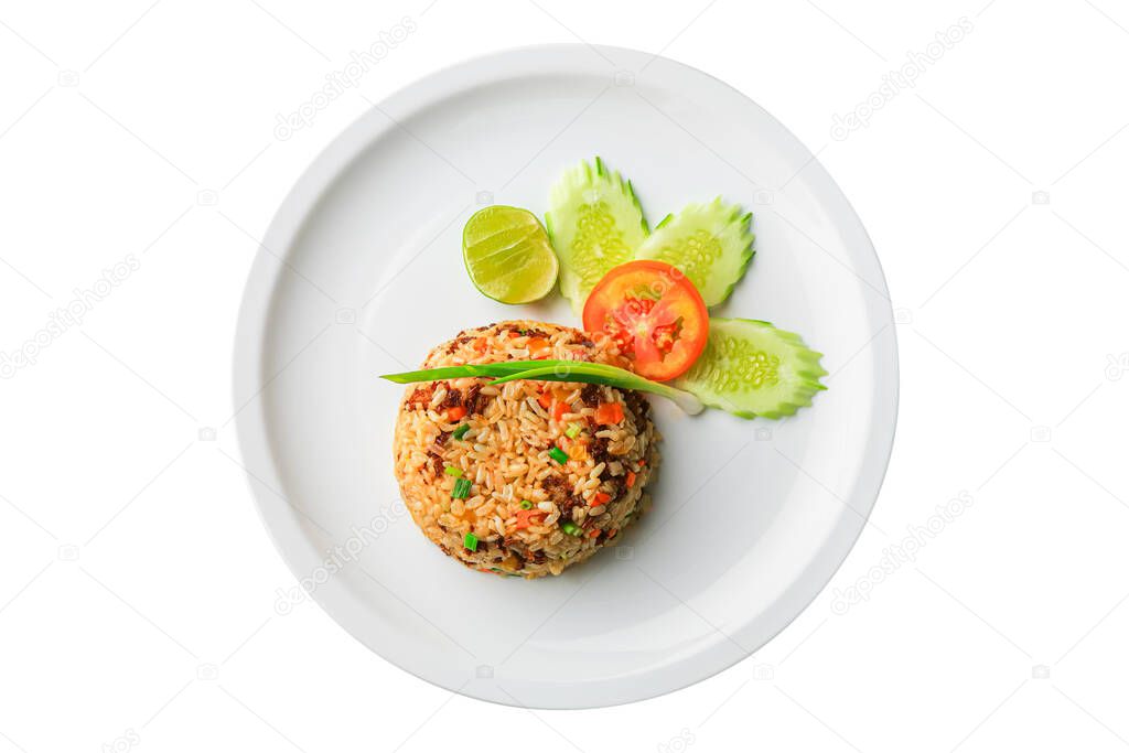 Above view of Asian fried rice with egg and vegetable in white ceramic plate isolated on white background. Khao Pad of Asian traditional style. Popular Thai food. Top view