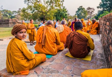 SAVATTTHI - 20 Şubat 2018 'de Savatthi, Hindistan' da eski Angulimala Stupa 'nın önünde oturan Budist keşişler.