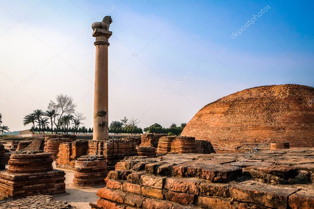 Pillars of Ashoka with blue sky at Vaishali in Bihar, India. Beautiful scenic view of monument ancient with lion pole top in summer day.