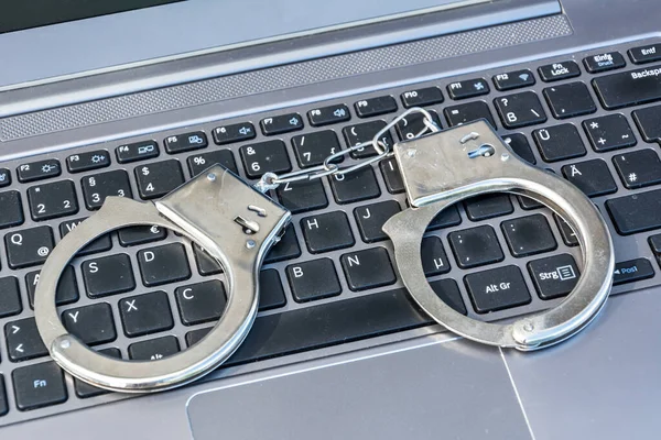 Siber suçların sembolü olarak bilgisayar klavyesinde duran kelepçeler