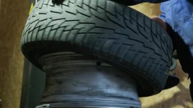 Change a tyre, Car mechanic is changing a tyre in a garage