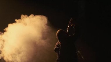 Man drinks alcohol in the dark and fog
