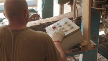 İşçi, CNC ile otomatik ahşap çalışma makinesinin kontrol paneli ile programı ayarlar