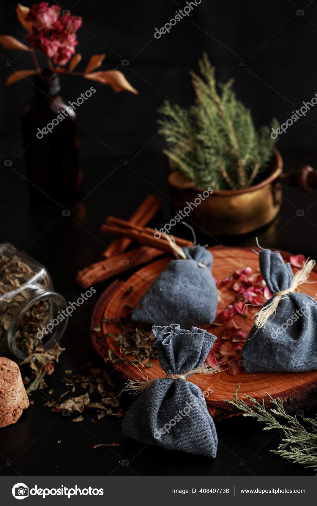 Flat lay of kitchen witchery using herbs and spices found at home. Herbal  magick in wicca and witchcraft. Glass jars filled with dried herbs and  spices, cinnamon, flowers, camomile, burning candles Stock