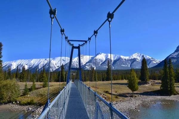 Ponte Suspensa Azul Sobre Rio Turquesa Altas Montanhas Cobertas Neve — Fotografia de Stock