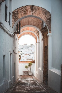İspanya, Vejer de la Frontera 'da Beyaz Duvarlarla çevrili bir kemer kapısı.