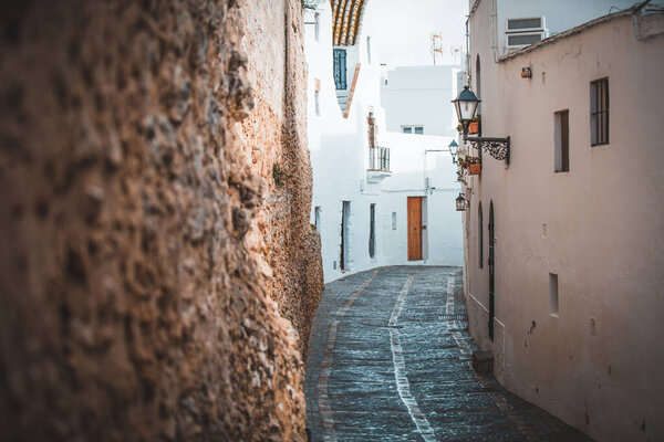 Curvy narrow pedestrian street in the old town village of Vejer de la Frontera, Spain