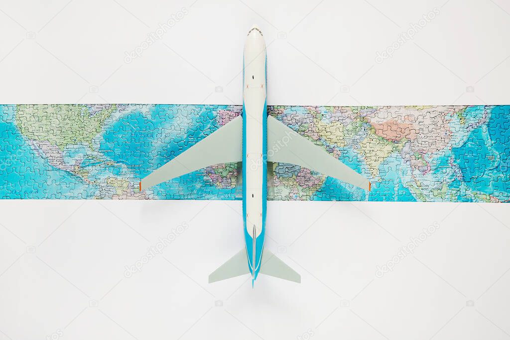 Model airplane opens world map. Resumption of flights after coronavirus pandemic. Opening borders. Quarantine Travel. World discovery concept. Copy space