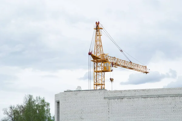 Tower crane. Crane and construction work. Yellow crane. Empty space for text. Construction concept. Website.