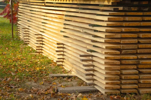 Long fresh boards lie flat stacks on the street in autumn. — Stock Image Long Fresh Boards Lie Flat Stacks Street Autumn Royalty Free Stock Images