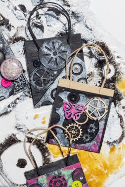 Çanta üst üste binen elementlerle süslenmiş ve steampunk stiliyle boyanmış. Kolaj kağıdı. Geri dönüştürülmüş malzeme ile el işi.