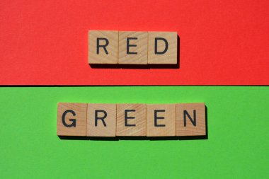 Kırmızı ve yeşil, kırmızı ve yeşil arkaplanda 3 boyutlu tahta alfabe harfleri.