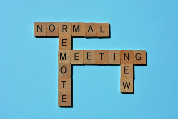 New Normal, Remote, Meeting, words in 3D wooden alphabet letters in crossword form isolated on blue background