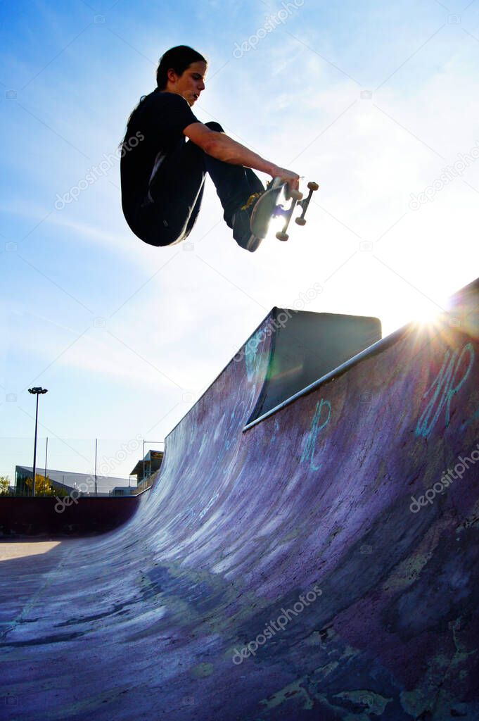 Skater doing a air trick on a skatepark