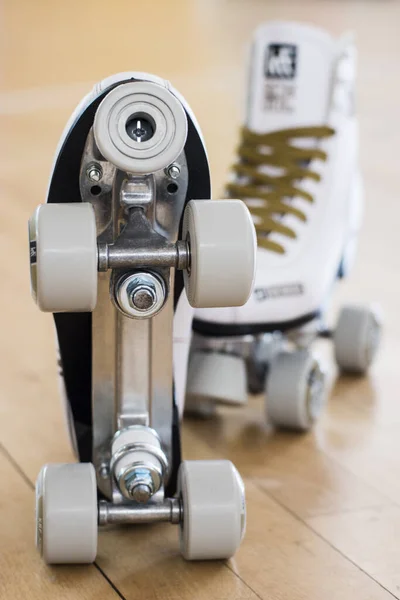 Roller skates on a wooden skating rink