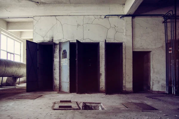 Room with different doors in an abandoned factory in Spain