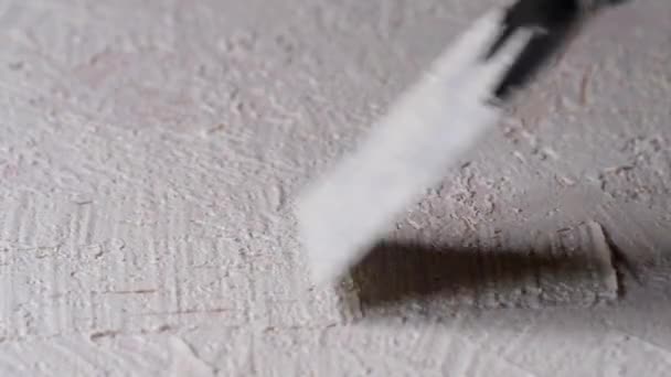 へらで水平な表面に白い粒状の石膏を塗り — ストック動画