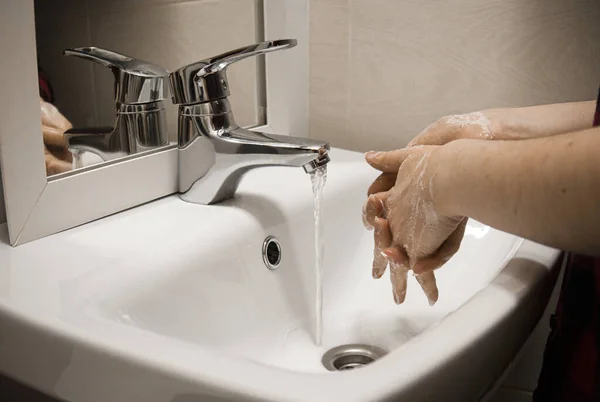 hand washing with a hand sanitizer prevents a viral infection of a person working at homeprevent the covid-19 virus