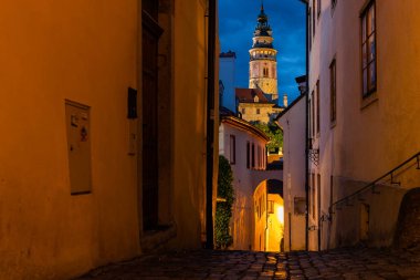 Gün batımında, Cesky Krumlov 'un dar sokağındaki sokak ışıklarıyla ünlü Cesky Krumlov Kalesi, UNESCO Dünya Mirası Bölgesi.