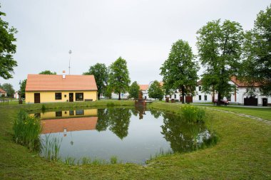 Holasovice, a small lake in the middle of a small baroque village, Unesco heritage, South Bohemia, Czech Republic clipart