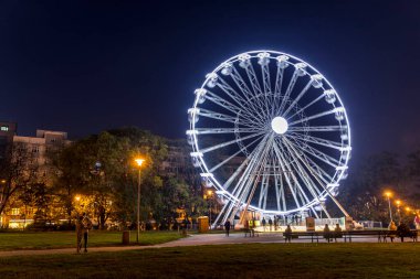 Brno 'daki Moravian Meydanı manzarası güzel olan insanlar için devasa bir Noel aydınlatma tekerleği soğuk bir akşamda hareket ederken hızlandırılmış video şehirdeki Noel hazırlıklarına hakim oluyor.