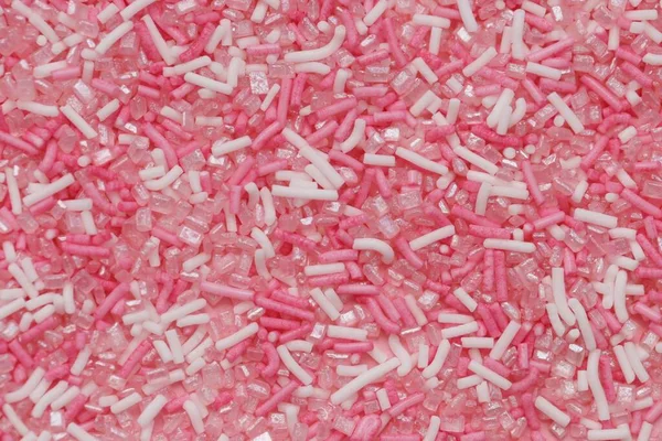 シュガースプリンクル 砂糖の装飾の背景ピンクと白の甘い装飾 — ストック写真