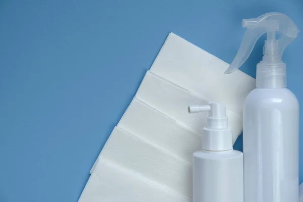 Hygiene sanitizer. Sanitizer for hands in white bottles and sanitary napkins