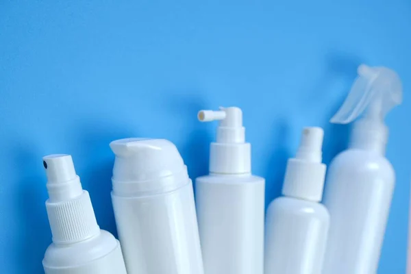 Plastic white bottles Mockup. Cosmetic bottles on a light blue background