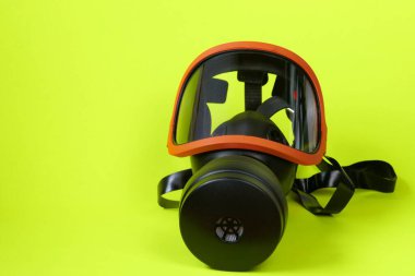 Filtreli koruyucu maske. Parlak sarı neon arka planda solunum cihazı olan güvenlik maskesi