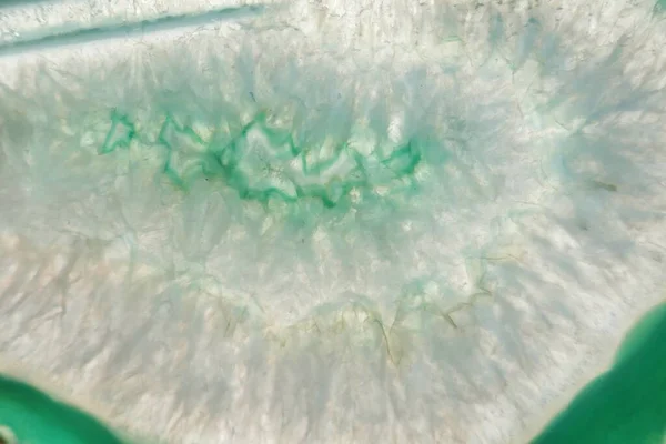 Green agate stone macro. Green agate arc slice texture.Natural stone bright Green background
