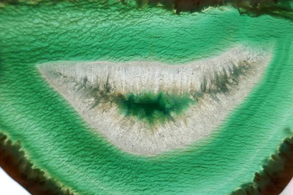 Green agate stone macro. Green agate arc slice texture.Natural stone bright Green background