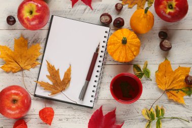 Düşen yapraklar ve not defteriyle sonbahar arkaplanı