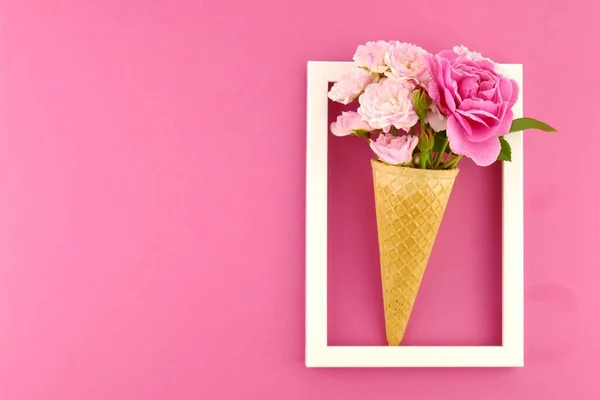 Flower card. Flower frame. Pink roses in an waffle cone in a white photo frame