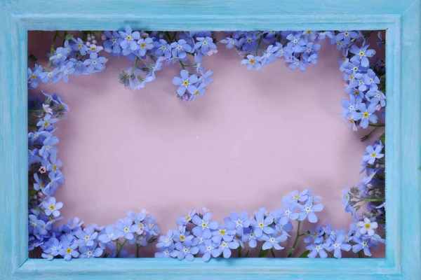 Flower card.Blue frame with gently blue forget-me-not flowers